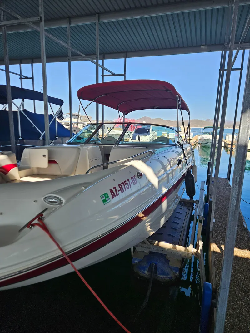 Slide: The Image of 2003 Chaparral Sunesta 263 boat docked with red canopy in marina. - 3