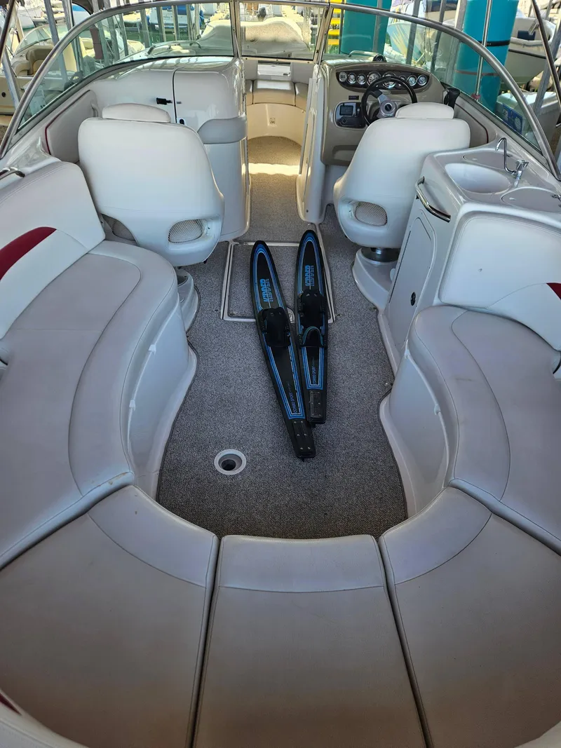Slide: The Image of 2003 Chaparral Sunesta 263 boat interior with seating and water skis. - 5