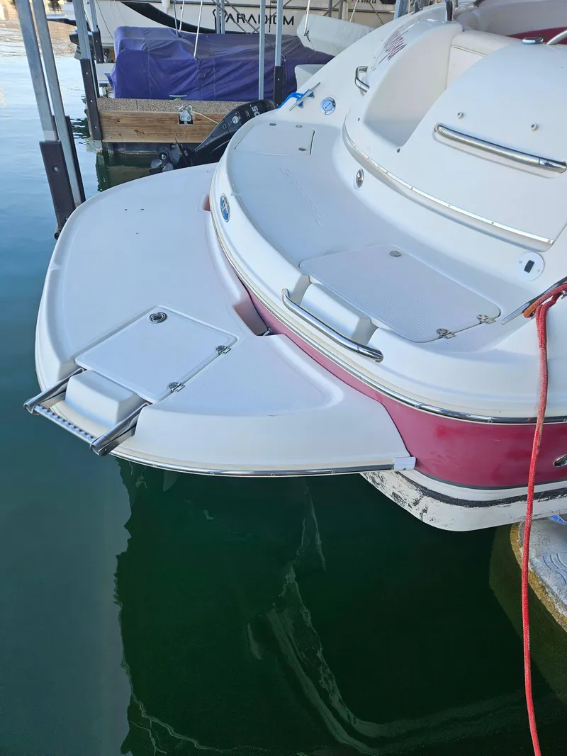 Slide: The Image of 2003 Chaparral Sunesta 263 boat with swim platform and ladder in marina. - 6