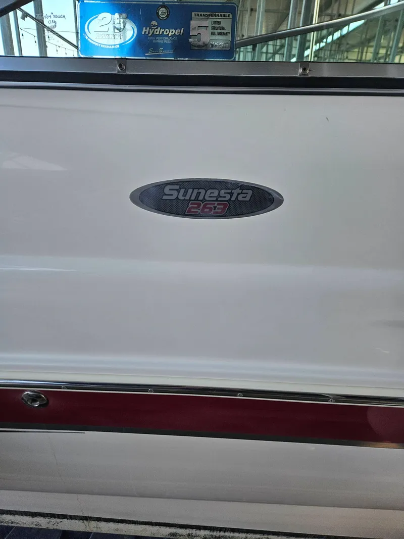 Slide: The Image of 2003 Chaparral Sunesta 263 boat emblem on white surface. - 8