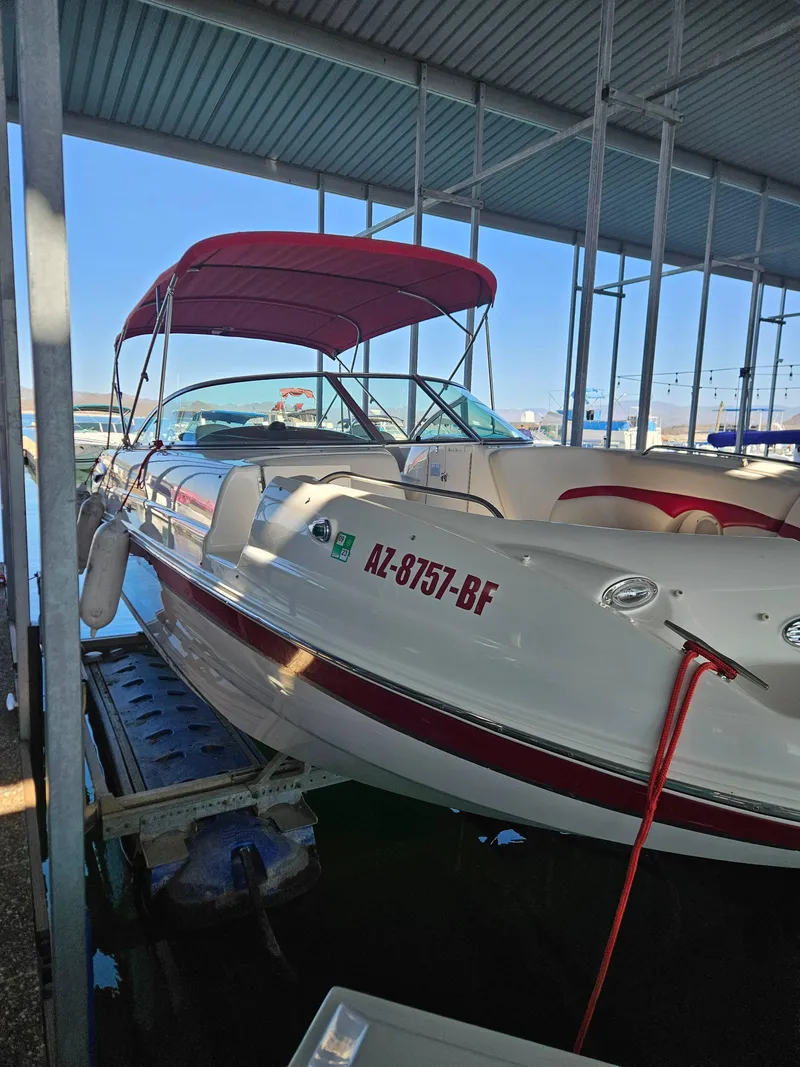 Slide: The Image of 2003 Chaparral Sunesta 263 boat with red canopy docked in marina. - 9