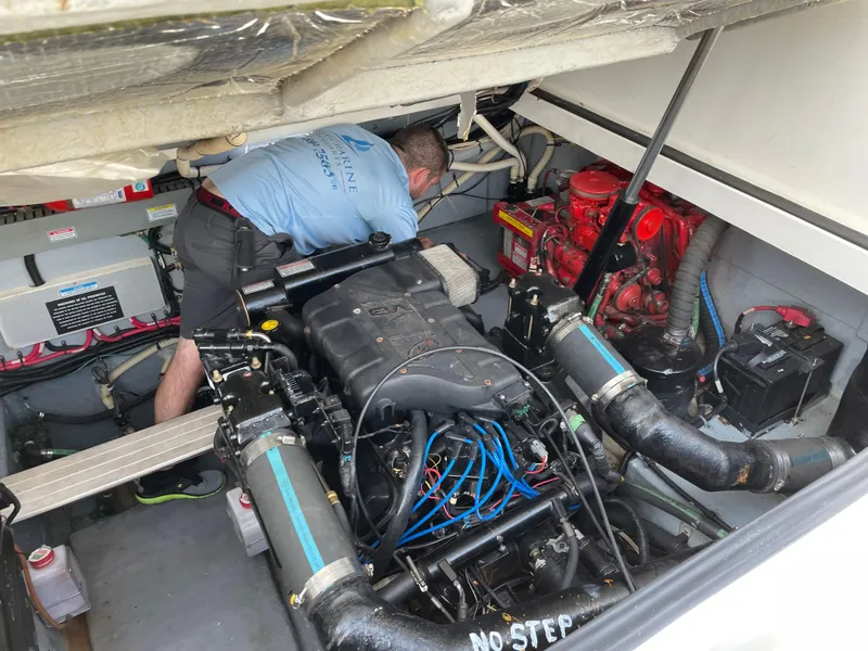 Slide: The Image of Engine compartment of a 1999 Sea Ray 370 Express Cruiser with a person performing maintenance. - 14