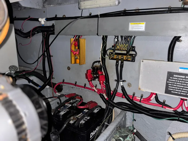 Slide: The Image of Engine room wiring of a 1999 Sea Ray 370 Express Cruiser with batteries and cables. - 17