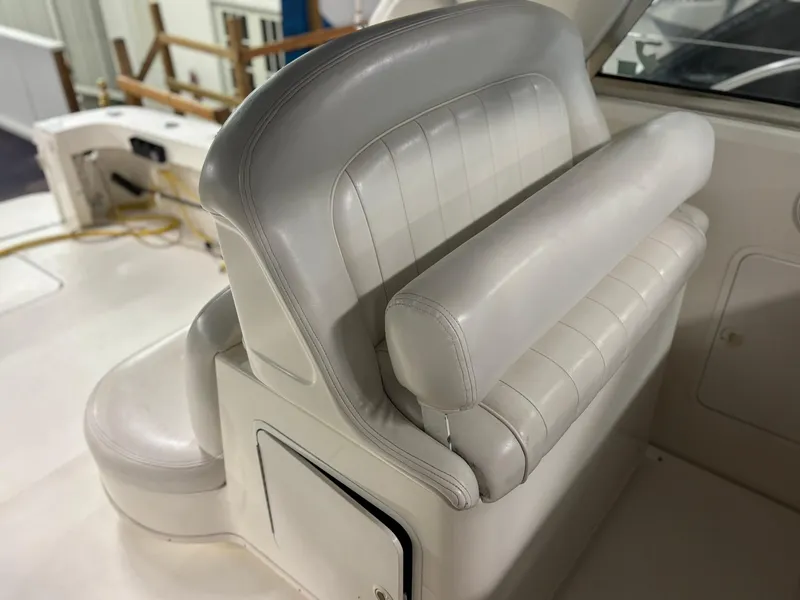 Slide: The Image of 1999 Sea Ray 370 Express Cruiser interior with white leather seating. - 19