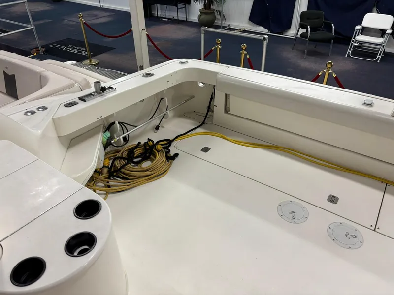 Slide: The Image of 1999 Sea Ray 370 Express Cruiser deck with coiled cables and cup holders. - 22