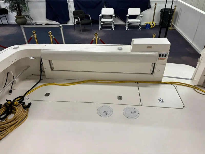 Slide: The Image of 1999 Sea Ray 370 Express Cruiser deck with storage compartments and coiled ropes. - 23