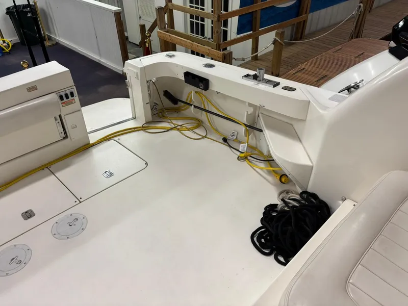 Slide: The Image of 1999 Sea Ray 370 Express Cruiser deck with cables and storage compartments. - 25
