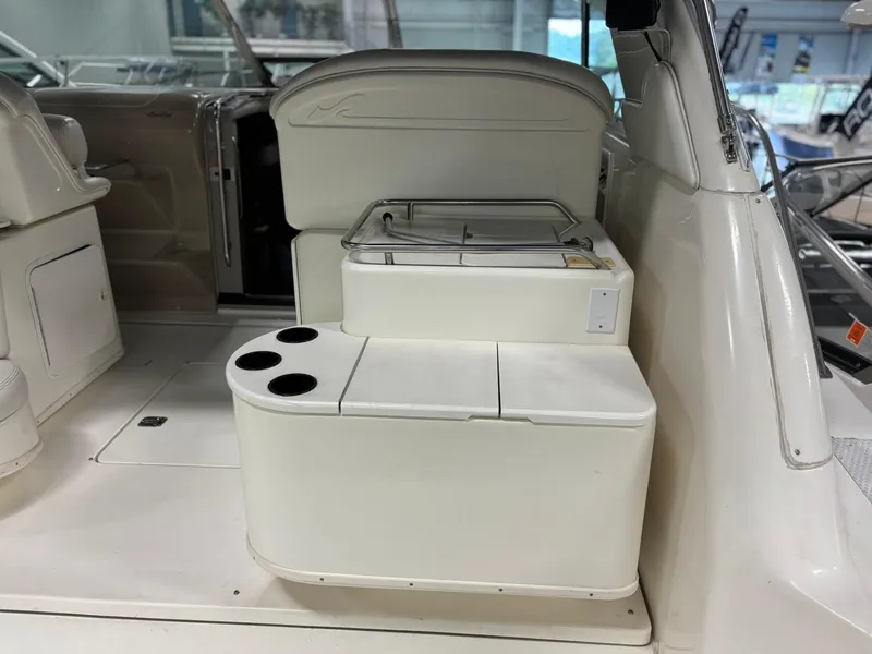 Slide: The Image of 1999 Sea Ray 370 Express Cruiser interior with seating and cup holders. - 28