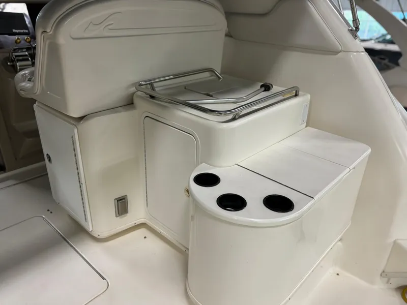 Slide: The Image of 1999 Sea Ray 370 Express Cruiser interior with cup holders and storage. - 31