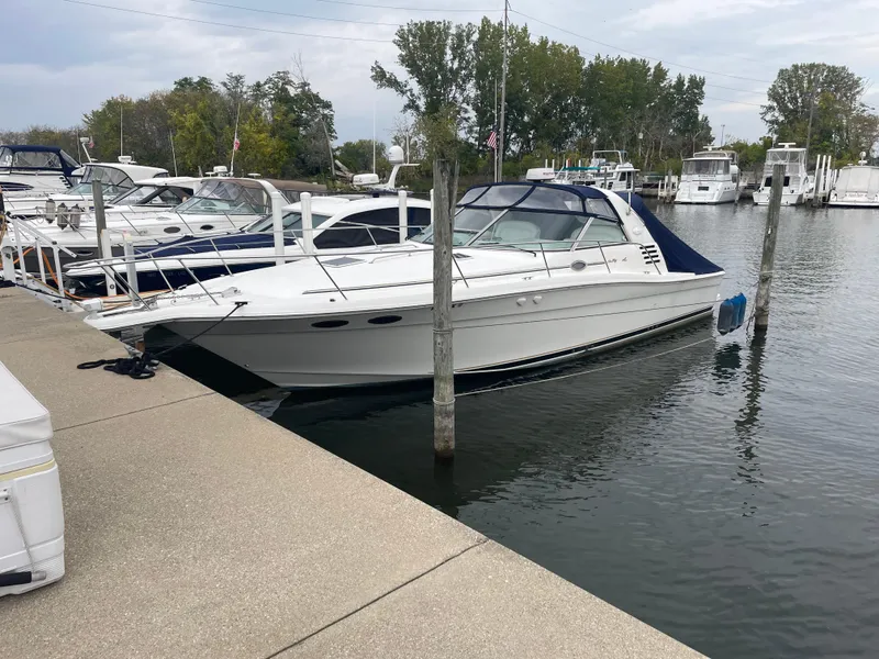 Slide: The Image of 1999 Sea Ray 370 Express Cruiser docked at a marina with other boats. - 4