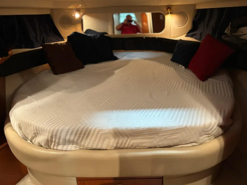 Slide: The Image of 1999 Sea Ray 370 Express Cruiser cabin with cozy bed and decorative pillows. - 41