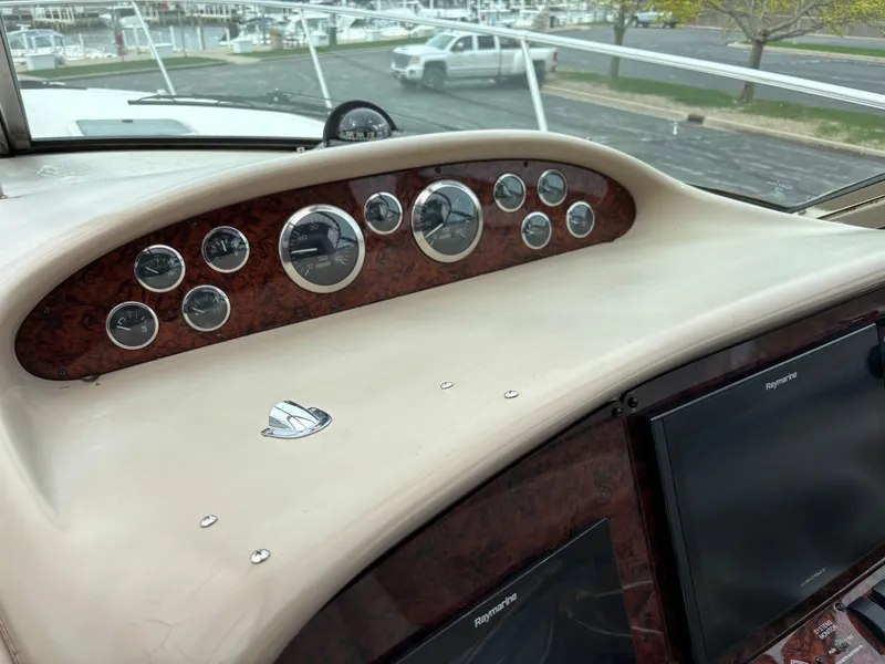 Slide: The Image of Dashboard of a 1999 Sea Ray 370 Express Cruiser with gauges and controls. - 9
