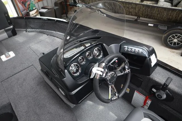 Slide: The Image of 2025 Lowe FM 1775 SC boat interior with modern dashboard and steering wheel. - 10