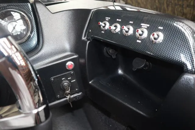Slide: The Image of Dashboard of 2025 Lowe FM 1775 SC boat with control switches and key ignition. - 11