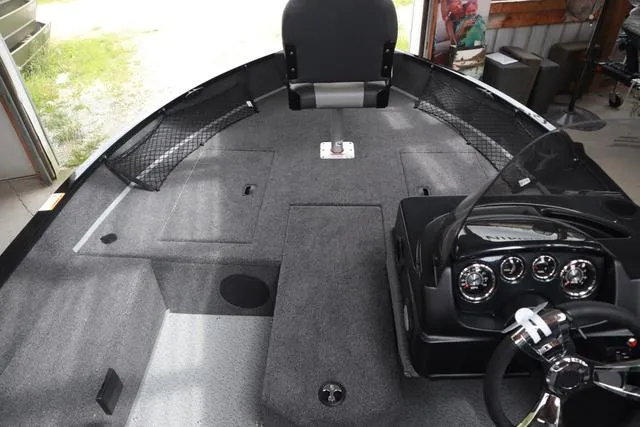Slide: The Image of 2025 Lowe FM 1775 SC boat interior with steering console and seating. - 13