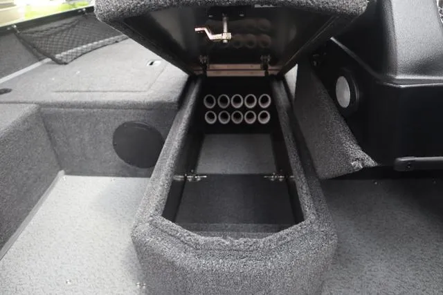 Slide: The Image of 2025 Lowe FM 1775 SC boat storage compartment with rod holders, open lid view. - 14