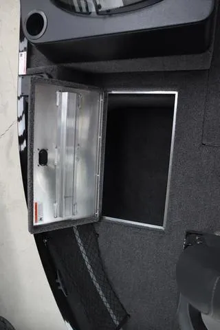Slide: The Image of 2025 Lowe FM 1775 SC boat storage compartment with open lid, showcasing interior space. - 16