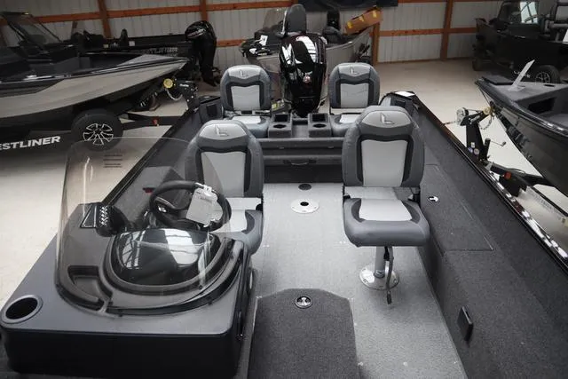 Slide: The Image of 2025 Lowe FM 1775 SC boat interior with seating and steering console. - 17