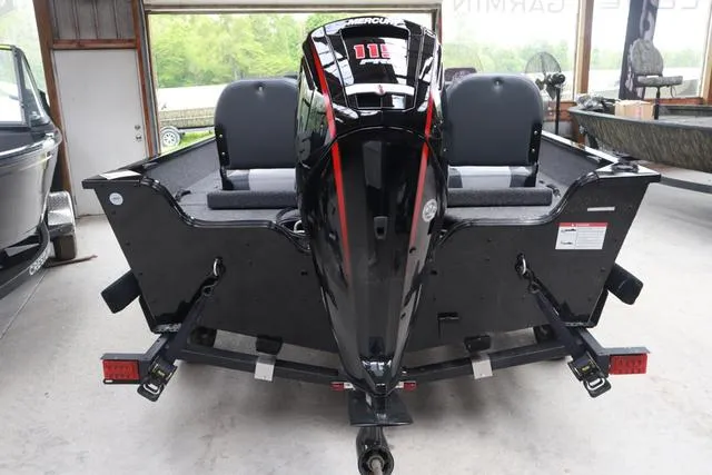 Slide: The Image of 2025 Lowe FM 1775 SC boat with powerful outboard motor in showroom. - 3