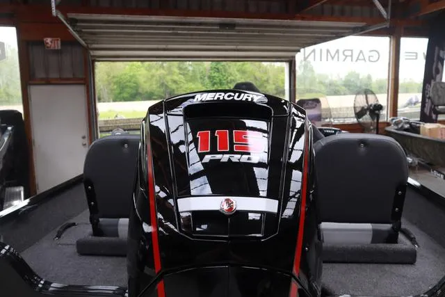 Slide: The Image of 2025 Lowe FM 1775 SC boat with Mercury 115 Pro outboard engine in a garage. - 4