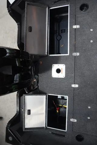 Slide: The Image of 2025 Lowe FM 1775 SC boat storage compartments with open lids, showcasing interior space. - 6