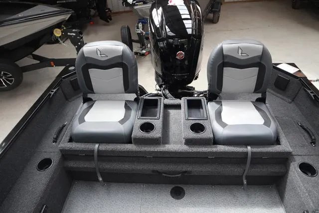 Slide: The Image of 2025 Lowe FM 1775 SC boat interior with dual seats and motor, featuring cup holders. - 7