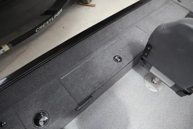 Slide: The Image of 2025 Lowe FM 1775 SC boat interior with carpeted flooring and seating. - 8