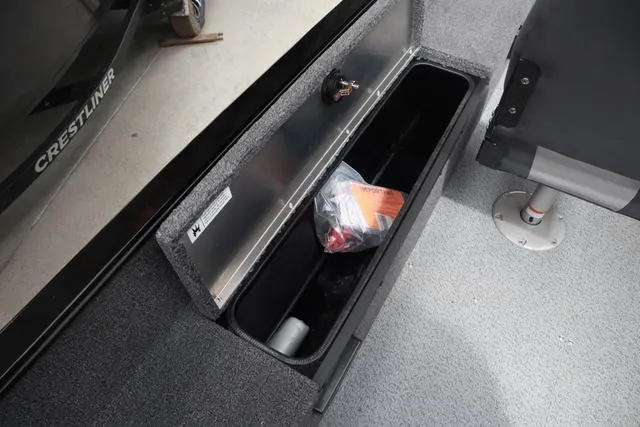 Slide: The Image of 2025 Lowe FM 1775 SC boat storage compartment with safety gear inside. - 9