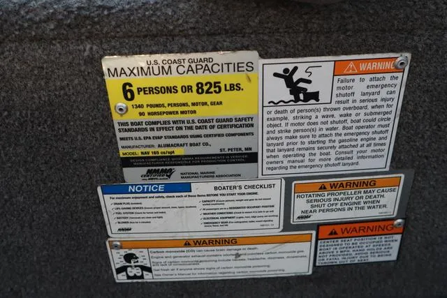 Slide: The Image of 2013 Alumacraft Navigator 165 CS capacity and safety warning labels. - 14