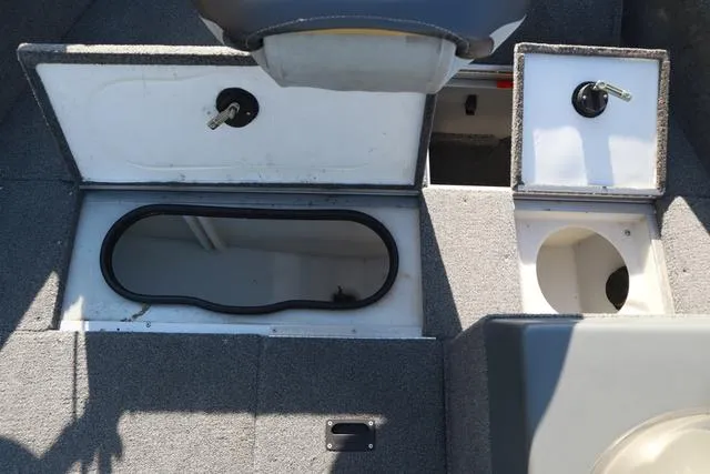 Slide: The Image of 2013 Alumacraft Navigator 165 CS boat interior with storage compartments. - 17