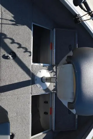 Slide: The Image of 2013 Alumacraft Navigator 165 CS boat interior with storage compartments and seating. - 18