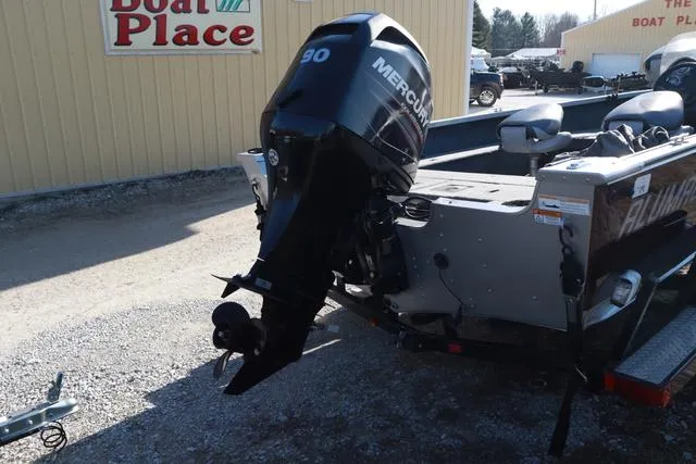 Slide: The Image of 2013 Alumacraft Navigator 165 CS with Mercury 90 outboard motor at a boat dealership. - 4