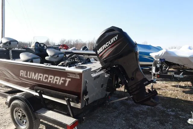 Slide: The Image of 2013 Alumacraft Navigator 165 CS boat with Mercury outboard motor on trailer. - 5