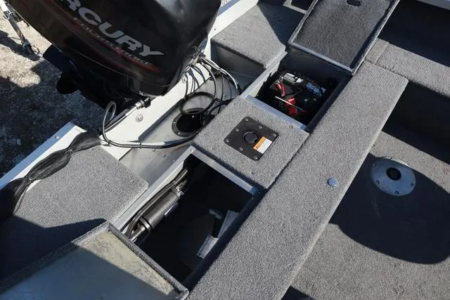 Slide: The Image of 2013 Alumacraft Navigator 165 CS boat interior with Mercury engine and storage compartments. - 7