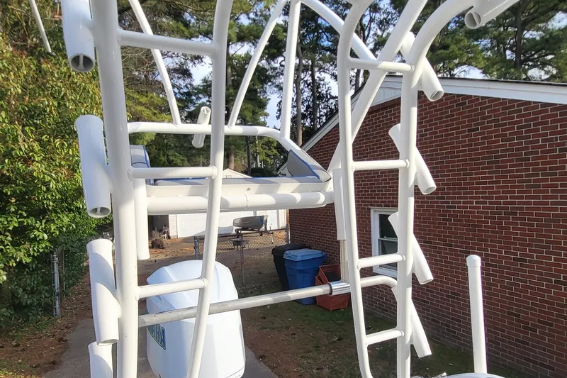 Slide: The Image of White metal framework of a 2012 Sea Fox 216 boat near a brick building. - 12