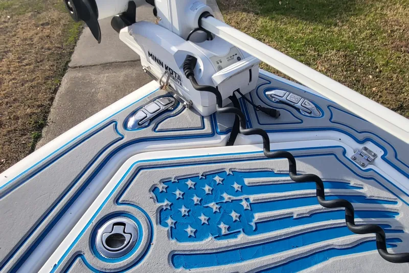 Slide: The Image of Sea Fox 216 boat deck with American flag design, featuring a Minn Kota trolling motor. - 13