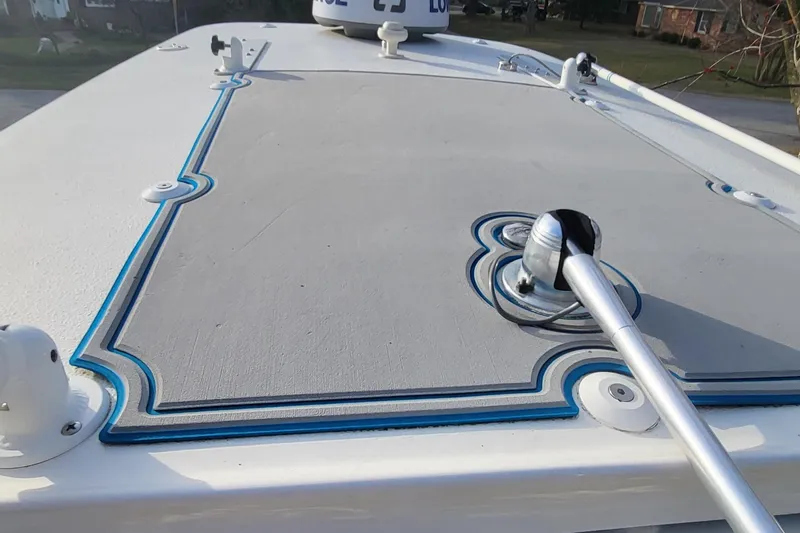 Slide: The Image of 2012 Sea Fox 216 boat deck with blue trim and mounted equipment. - 15