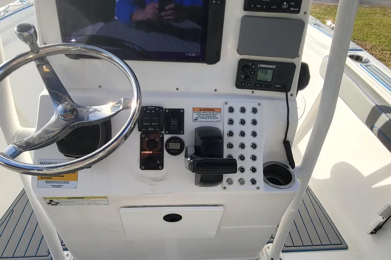 Slide: The Image of Control panel of a 2012 Sea Fox 216 boat with steering wheel and electronics. - 17