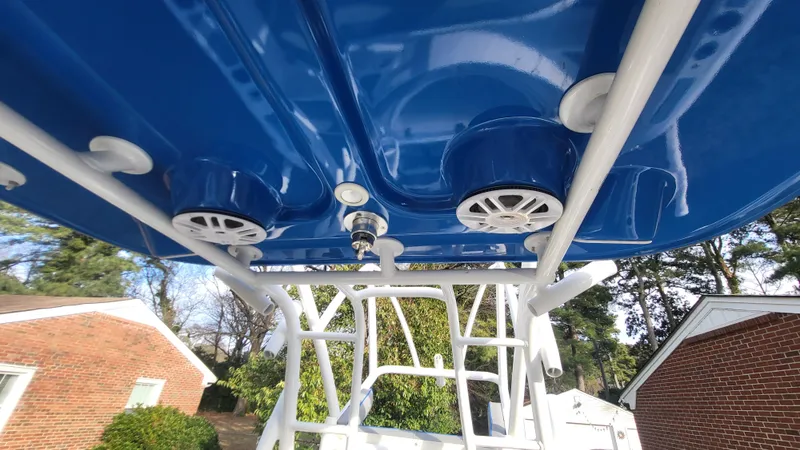 Slide: The Image of 2012 Sea Fox 216 boat with blue canopy and mounted speakers. - 18