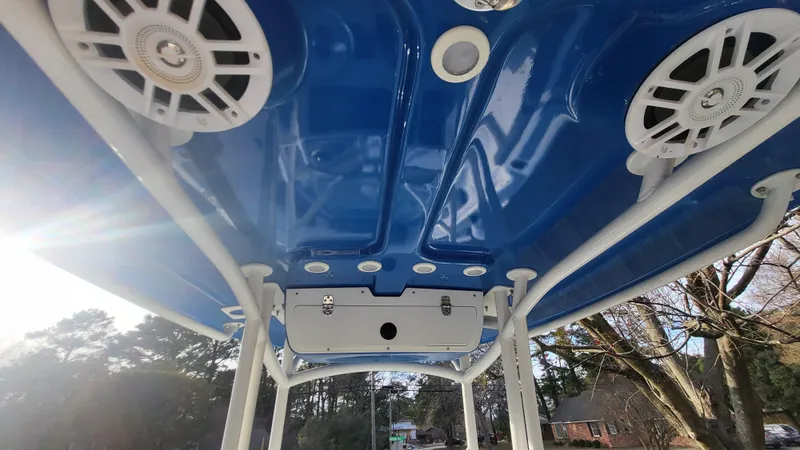 Slide: The Image of 2012 Sea Fox 216 boat T-top with blue finish and integrated speakers. - 19