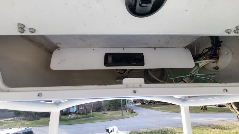 Slide: The Image of Storage compartment of a 2012 Sea Fox 216 boat with wiring and control panel. - 21