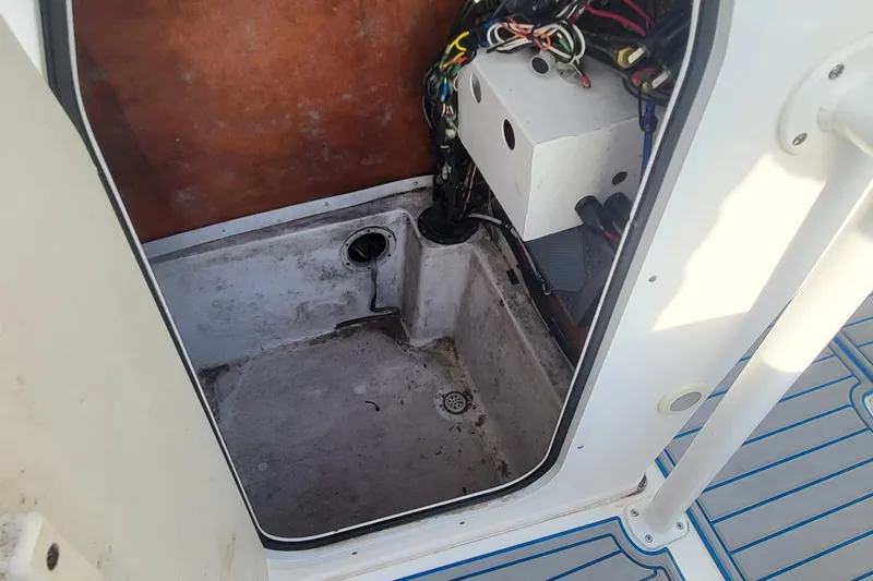 Slide: The Image of 2012 Sea Fox 216 boat compartment with wiring and drainage system. - 25