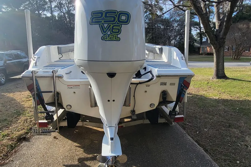 Slide: The Image of 2012 Sea Fox 216 boat with 250 V6 4.2L engine, parked on a driveway. - 3