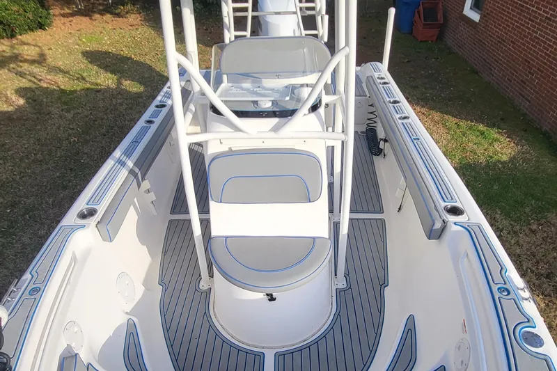 Slide: The Image of 2012 Sea Fox 216 boat interior with seating and steering console, featuring sleek design and spacious layout. - 7