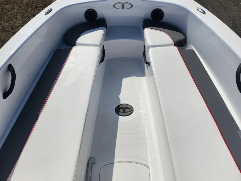 Slide: The Image of 2023 Tahoe T18 boat interior with white seating and red trim accents. - 14