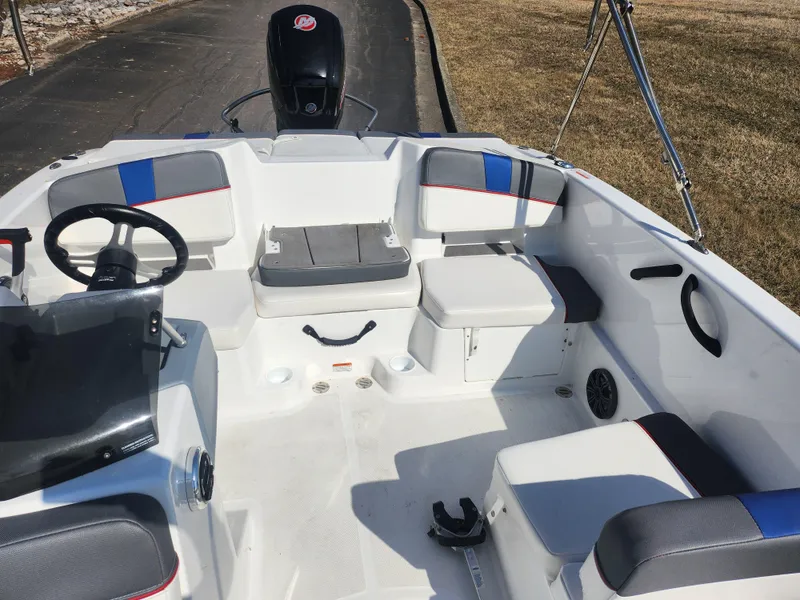 Slide: The Image of 2023 Tahoe T18 boat interior with seating, steering wheel, and storage compartments. - 18