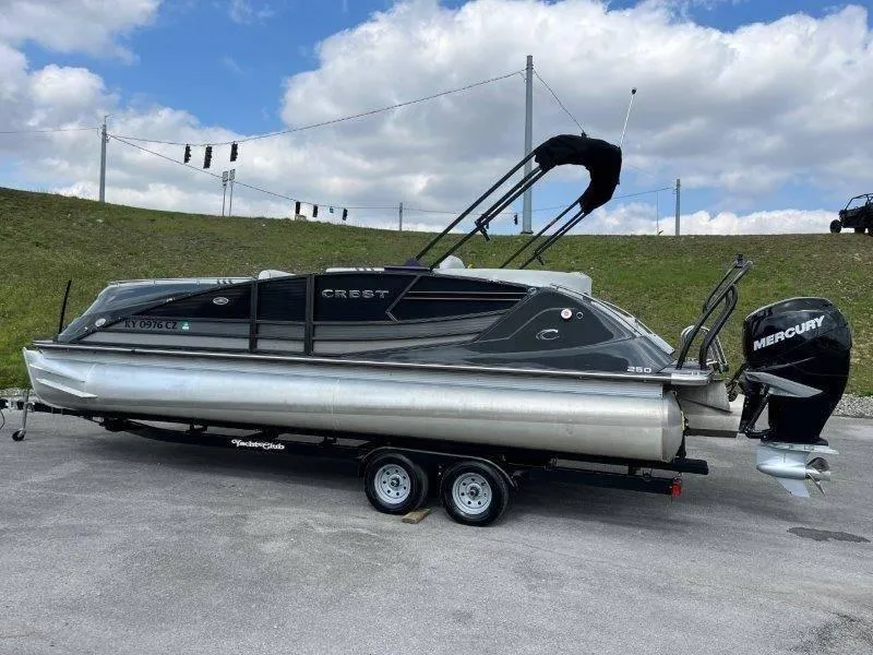 Slide: The Image of 2018 Crest Savannah 250 NX-L pontoon boat on trailer, with Mercury outboard motor. - 12