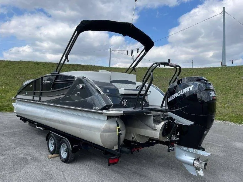 Slide: The Image of 2018 Crest Savannah 250 NX-L pontoon boat with Mercury engine on trailer. - 17