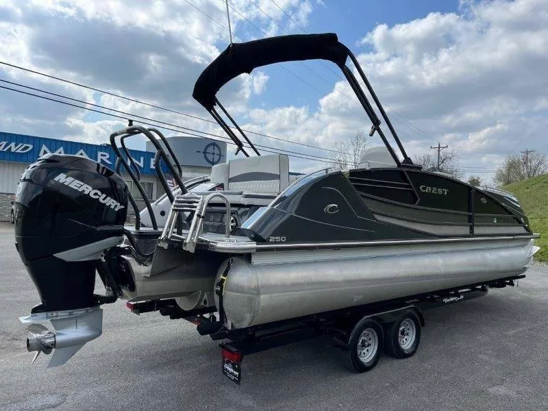 Slide: The Image of 2018 Crest Savannah 250 NX-L pontoon boat with Mercury engine on trailer. - 22
