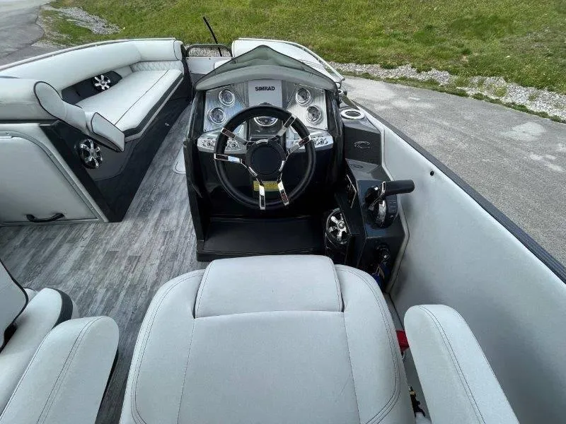 Slide: The Image of 2018 Crest Savannah 250 NX-L boat interior with steering wheel and seating. - 25